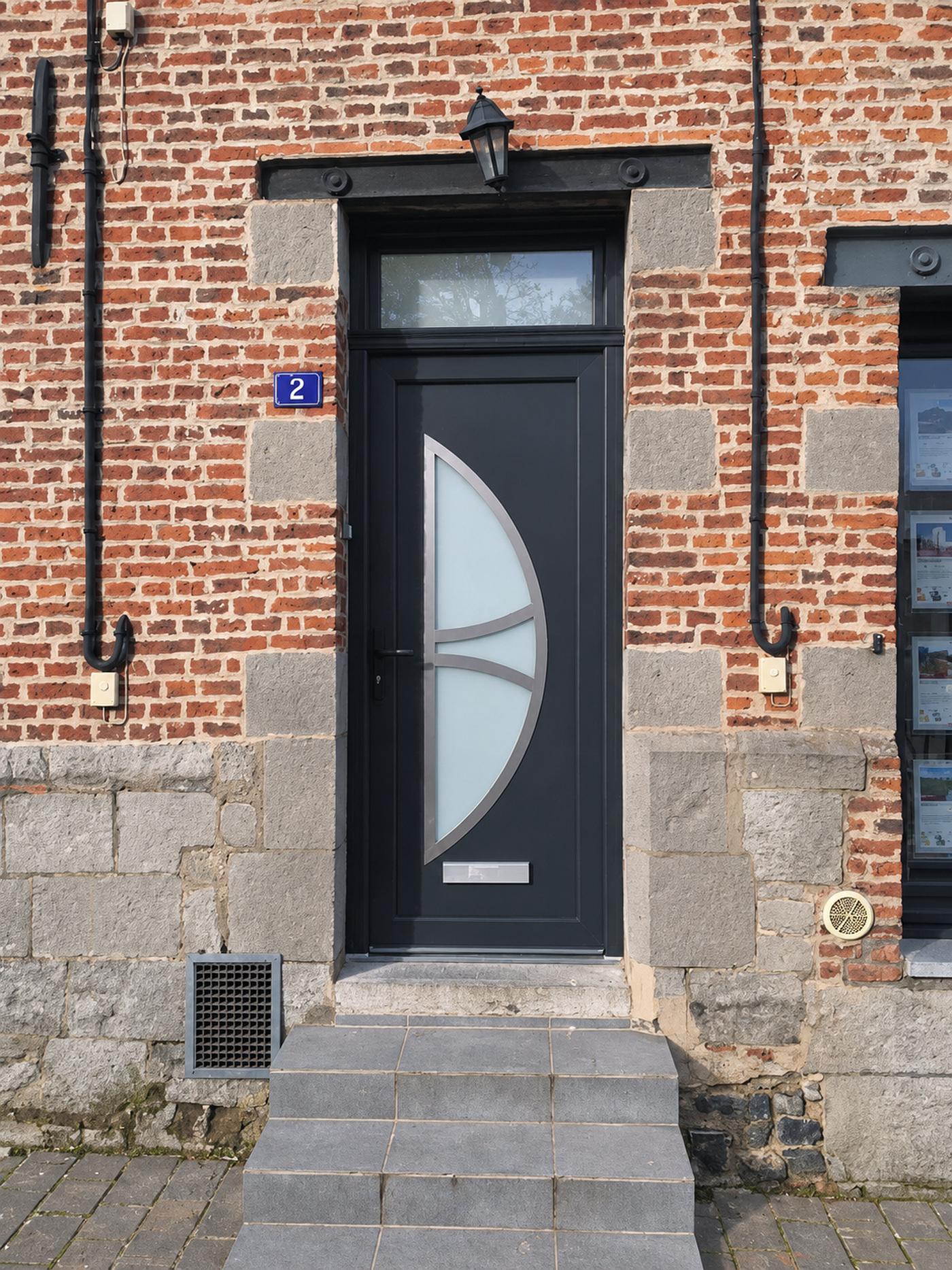 Réalisation VITREC d'une porte d'entrée anthracite avec vitrage demi-lune et imposte vitrée